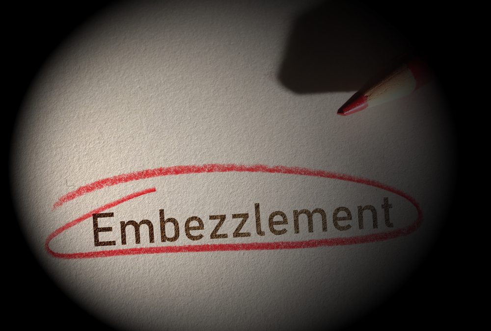 Embezzlement,Text,Circled,In,Red,Pencil,On,A,Dark,Background