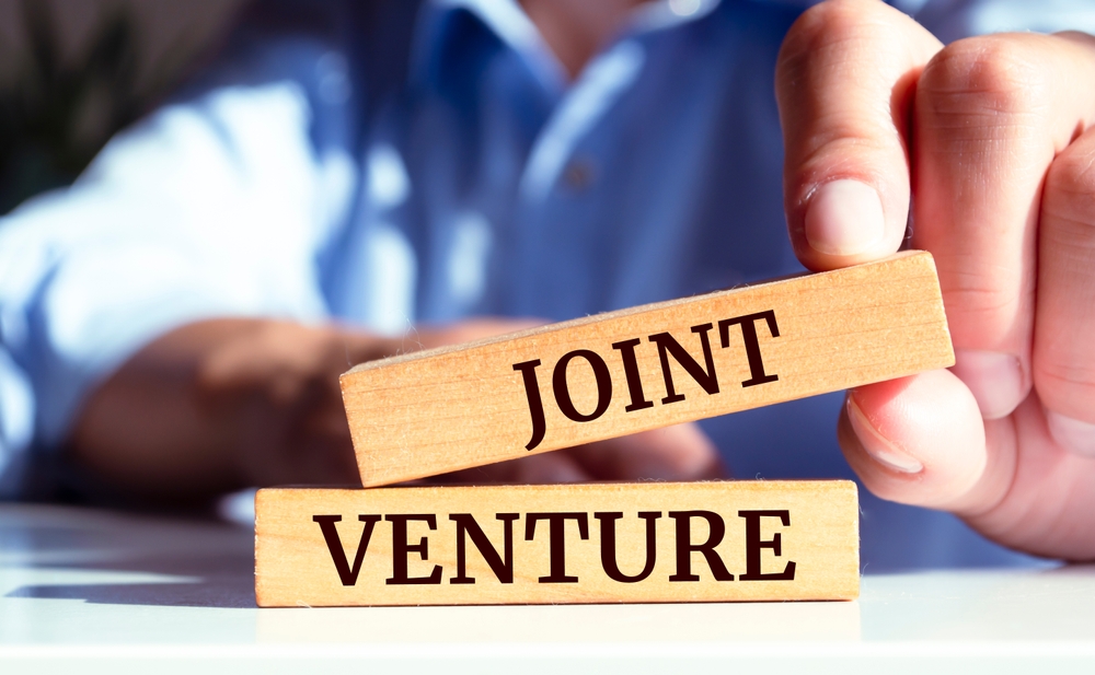 Close,Up,On,Businessman,Holding,A,Wooden,Block,With,"joint