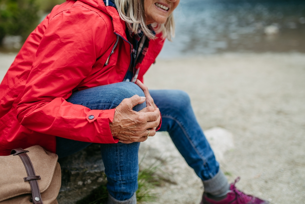 Senior,Woman,Injured,Leg,During,Hike,In,The,Mountains.,Tourist