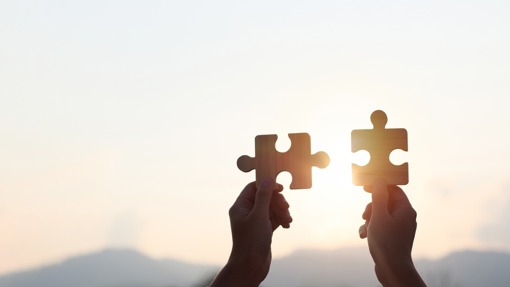 Teamwork,And,Partnership,Concept.,Hands,Are,Raised,Against,A,Bright,