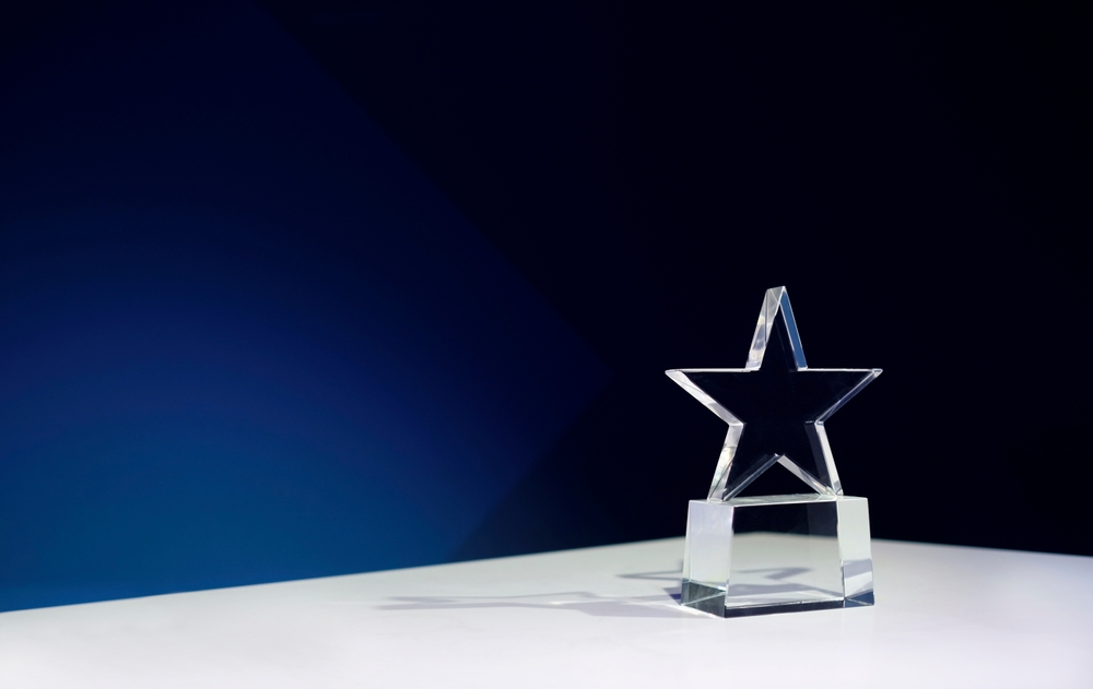 Star Shaped,Award,On,A,Table,With,Spotlights,And,Copy,Space